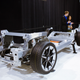 The FF 91's skateboard chassis. Note the modular front strut bracing, the two electric motors in the back, and the orange batteries laid out in six crosswise strings. Photo Credit: Raphael Orlove